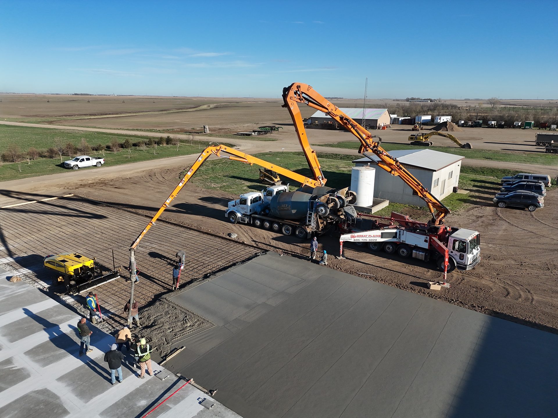 A large commercial concrete pour with two pump trucks